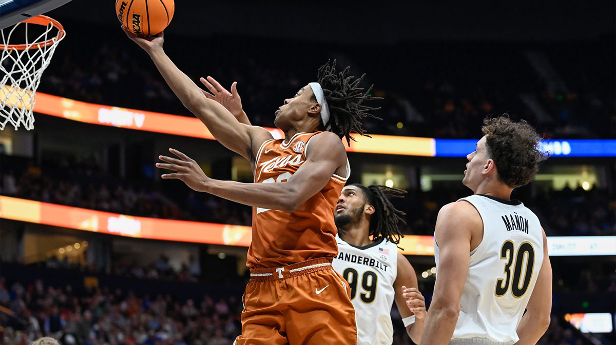 Texas guard Tre Johnson (20) drives past Vanderbilt guard Chris Manon (30) and forward Devin McGlockton (99) during the first half at Bridgestone Arena in Nashville, Tenn.