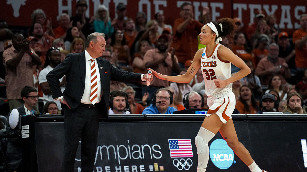 Texas women's basketball head coach Vic Schaefer greets guard Ndjakalenga Mwenentanda (32) as she leaves the court late in the fourth quarter during the second round NCAA playoff game against Illinois.