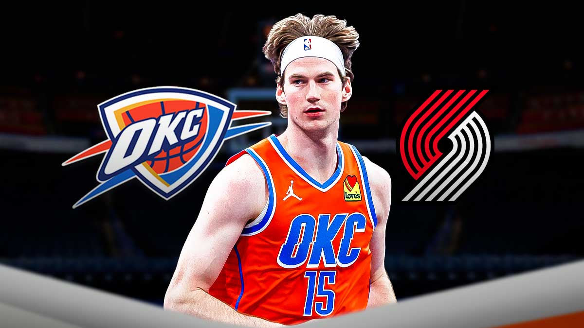Thunder center Branden Carlson next to the Thunder and Trail Blazers logo with the Paycom Center in the background from the OKC Blue
