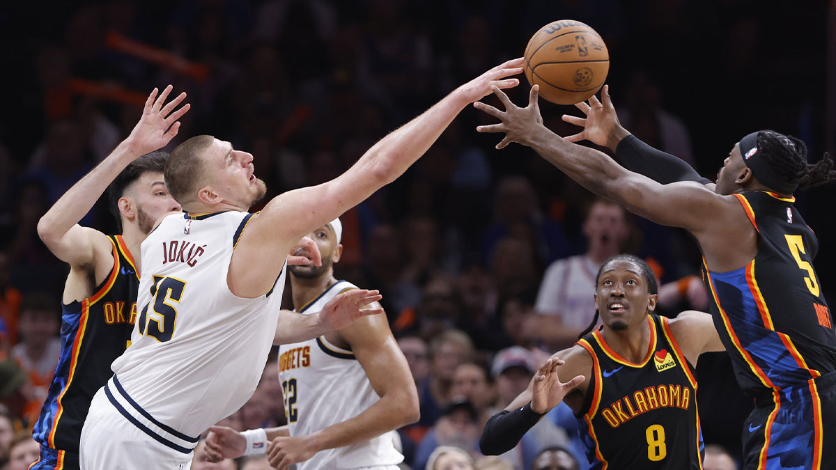 Denver Nuggets center Nikola Jokic (15) and Oklahoma City Thunder guard Luguentz Dort (5) reach for a loose ball during the second half at Paycom Center. 