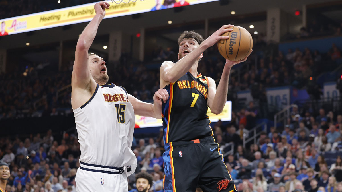 Thunder forward Chet Holmgren (7) goes up for a basket beside Denver Nuggets center Nikola Jokic (15) during the second half at Paycom Center