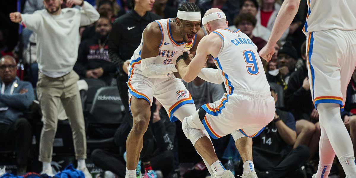 Thunder guard Shai Gilgeous-Alexander (2) celebrates with guard Alex Caruso (9) during the second half against the Portland Trail Blazers at Moda Center