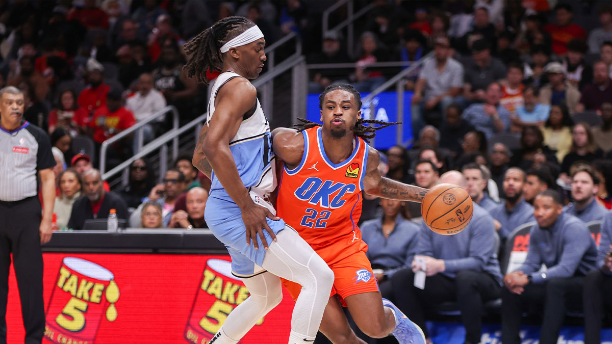  Thunder guard Cason Wallace (22) drives on Atlanta Hawks guard Terance Mann (14) in the second quarter at State Farm Arena