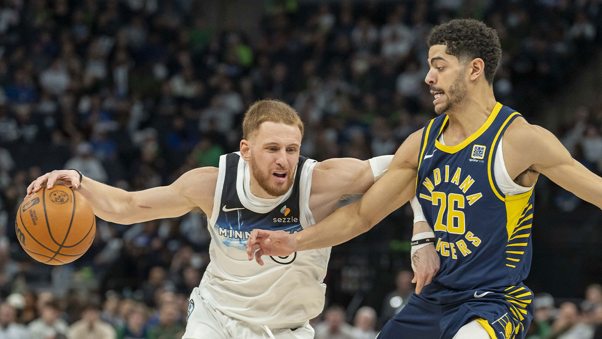 Timberwolves guard Donte DiVincenzo (0) dribbles the ball past Indiana Pacers guard Ben Sheppard (26) in the first half at Target Center