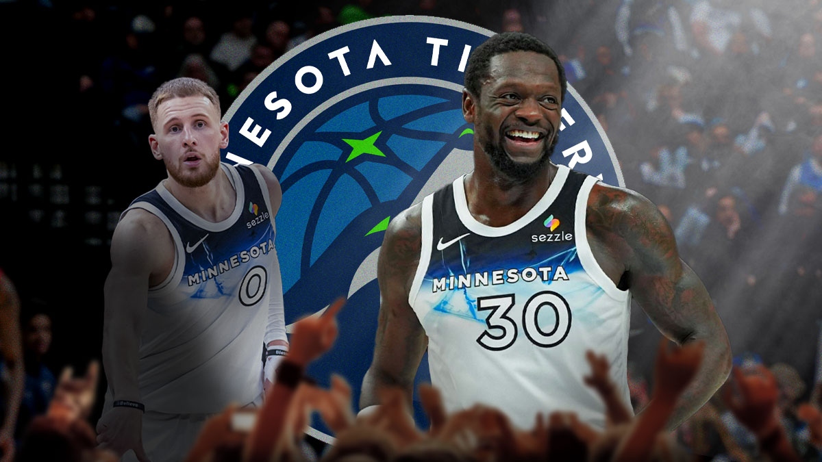 Timberwolves forward Julius Randle next to Timberwolves guard Donte DiVincenzo (shadowed out) with Timberwolves fans and the Timberwolves logo in the background