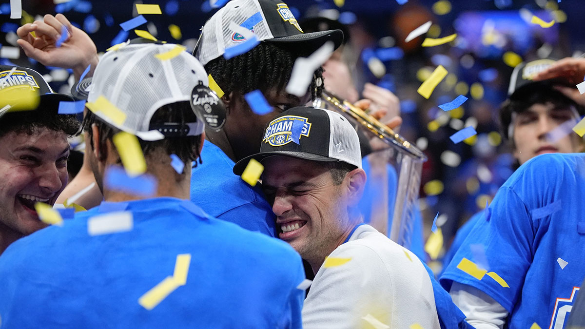 Florida head coach Todd Golden and the team celebrate their win over Tennessee after the Southeastern Conference tournament championship at Bridgestone Arena in Nashville, Tenn., Sunday, March 16, 2025.