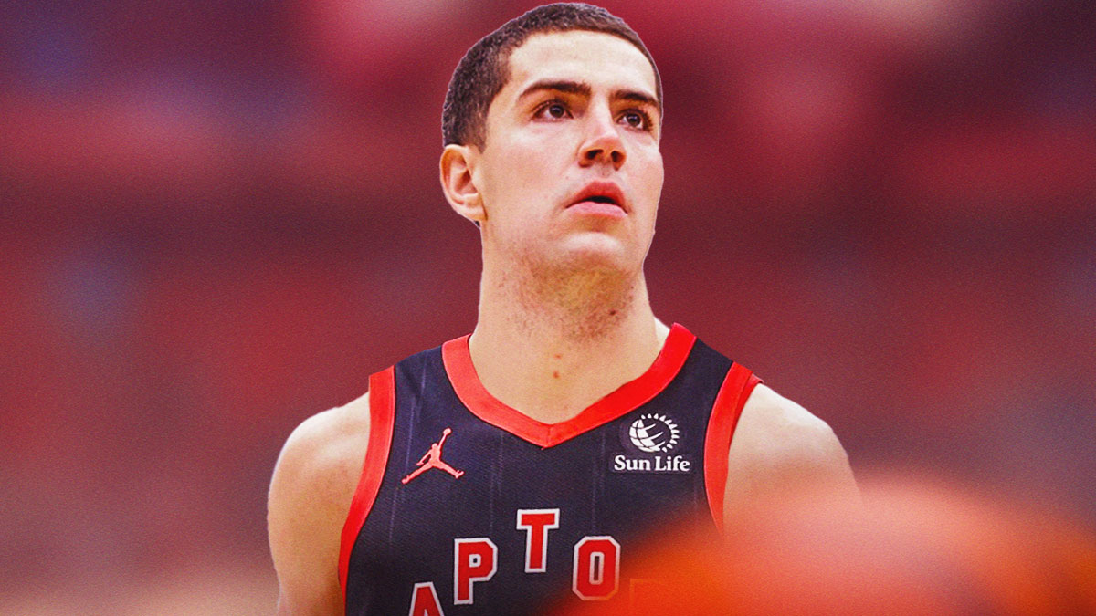 NBA player Cole Swider in a Toronto Raptors jersey with the Raptors arena in the background roster signing