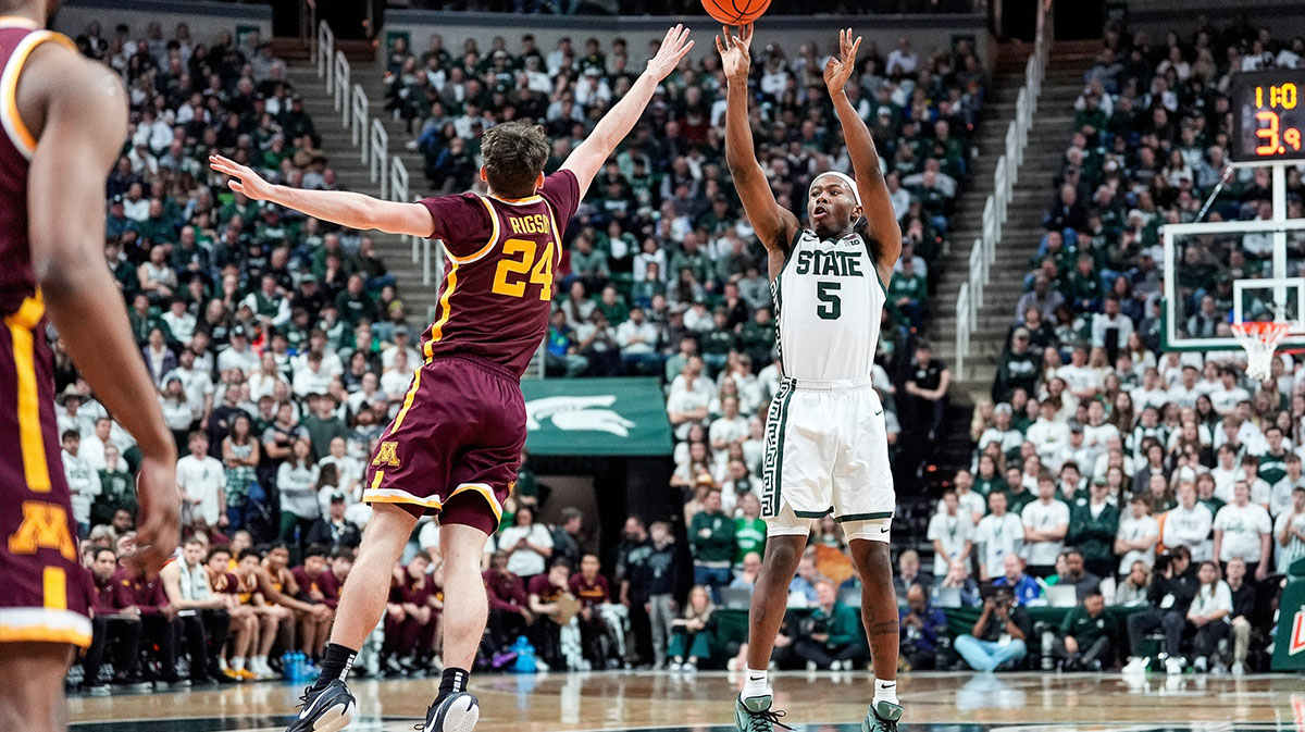 Michigan State guard Tre Holloman (5) makes a jump shot against Minnesota guard Brennan Rigsby (24) during the second half at Breslin Center