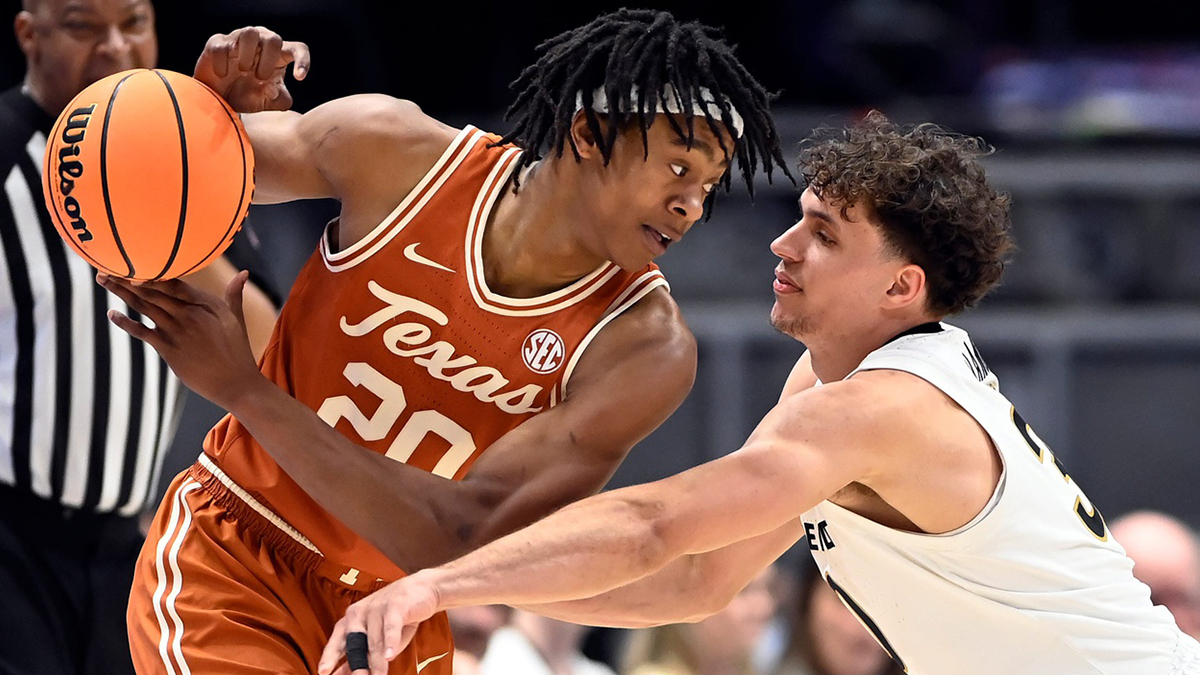 Texas Guard Tre Johnson (20) holds the ball from Vanderbilt Guard Chris Manon (30) during the NCA Faculty Basketball player in the southeast game in the southeastern conference tournament 