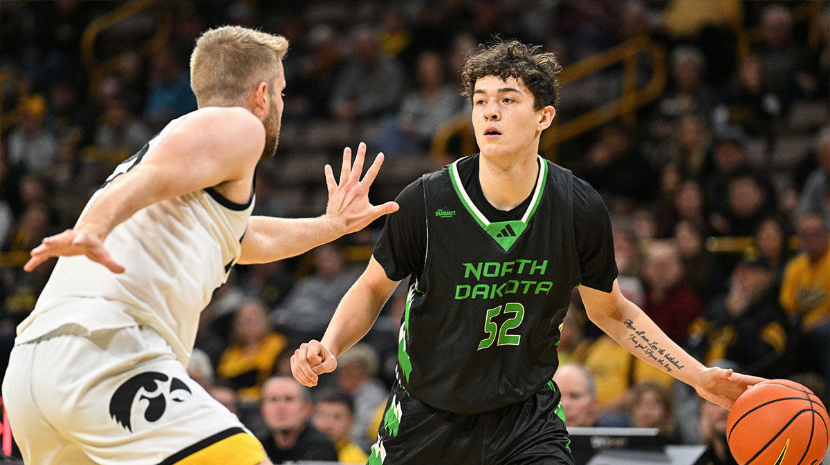 North Dakota Fighting Hawks basketball guard Treysen Eaglestaff (52) dribbles against Iowa Hawkeyes forward Ben Krikke (23) during the first half at Carver-Hawkeye Arena. 