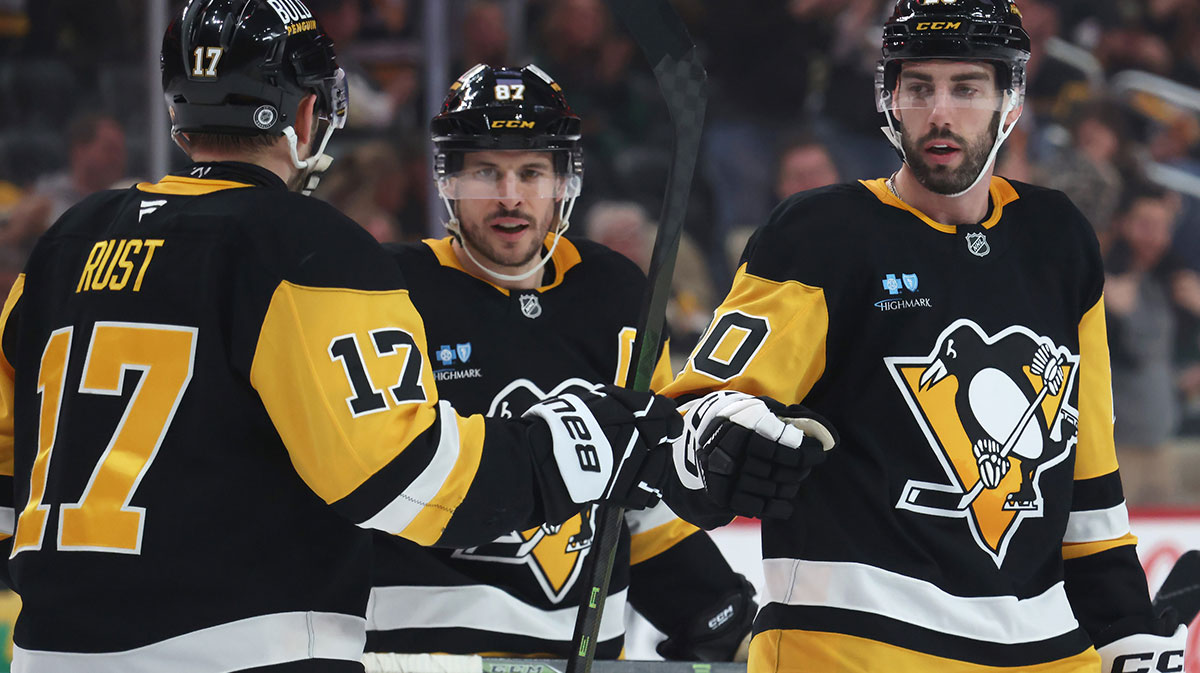 Pittsburgh Penguins right wing Bryan Rust (17) celebrates his empty net goal with center Sidney Crosby (87) and defenseman Conor Timmins (20) against the Columbus Blue Jackets during the third period at PPG Paints Arena.