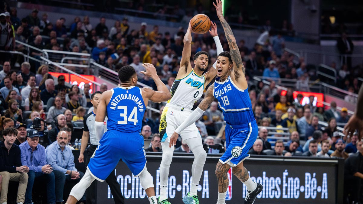 Indiana Pacers guard Tyrese Haliburton (0) passes the ball while Milwaukee Bucks forward Kyle Kuzma (18) defends in the first half at Gainbridge Fieldhouse.
