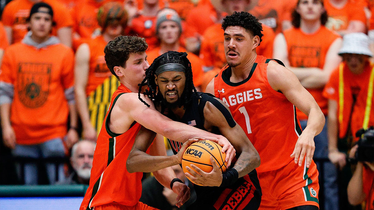 UNLV Rebels forward Keylan Boone (20) battles for the ball with Colorado State Rams forward Patrick Cartier (12) and forward Joel Scott (1) in the second half at Moby Arena.