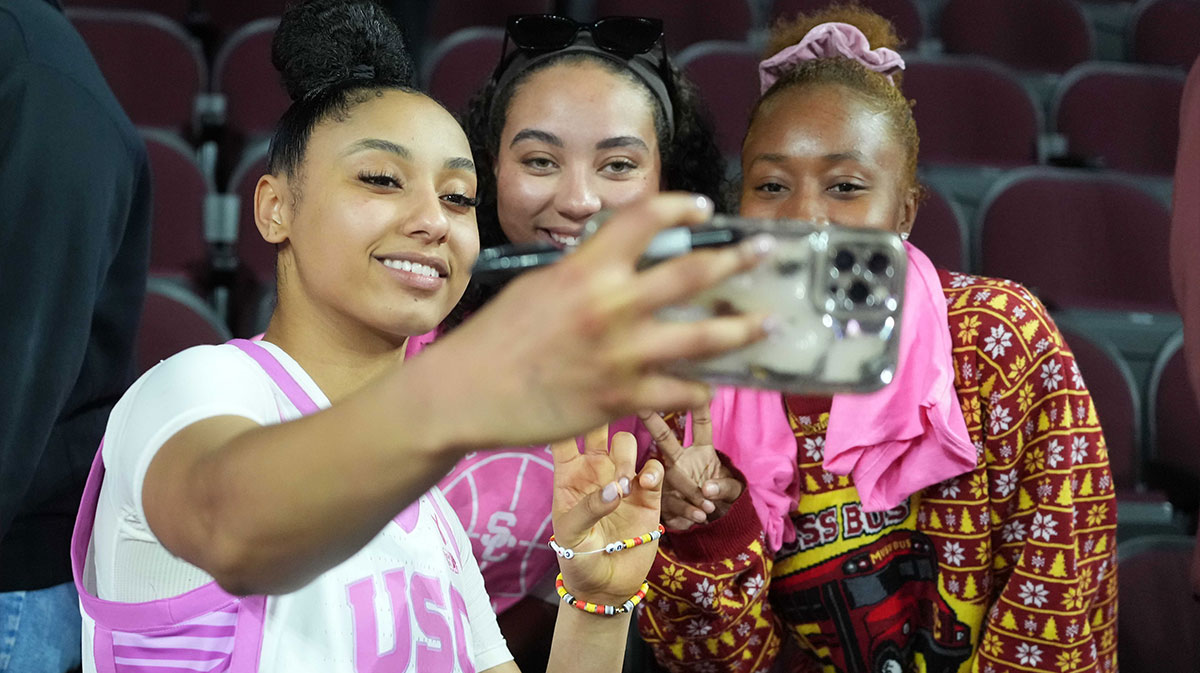 Southern California Trojans guard JuJu Watkins (12) poses for a selfie with fans after the game against the Michigan State Spartans.
