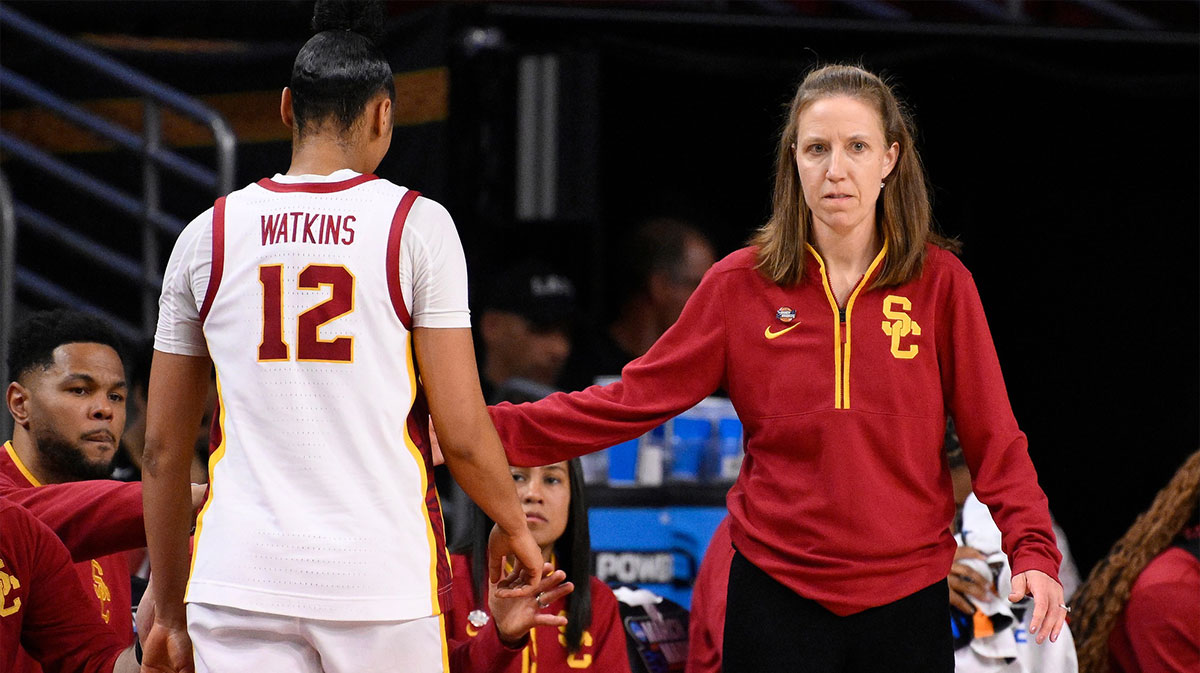 USC women's basketball head coach Lindsay Gottlieb greets guard JuJu Watkins (12) as she comes out of the game in the fourth quarter of an NCAA Tournament game against the UNC Greensboro Spartans.