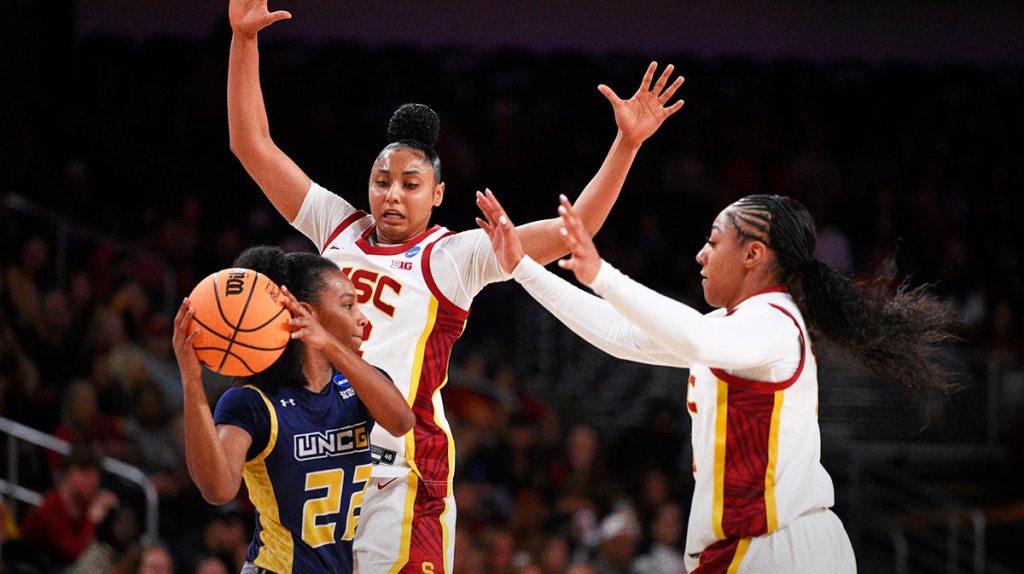 UNC Greensboro Spartans guard Nya Smith (22) is double teams by USC Trojans guards JuJu Watkins (12) and Kennedy Smith (11) during the second quarter.