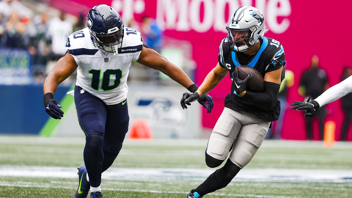 Sep 24, 2023; Seattle, Washington, USA; Carolina Panthers wide receiver Adam Thielen (19) runs for yards after the catch against Seattle Seahawks linebacker Uchenna Nwosu (10) during the first quarter at Lumen Field. 