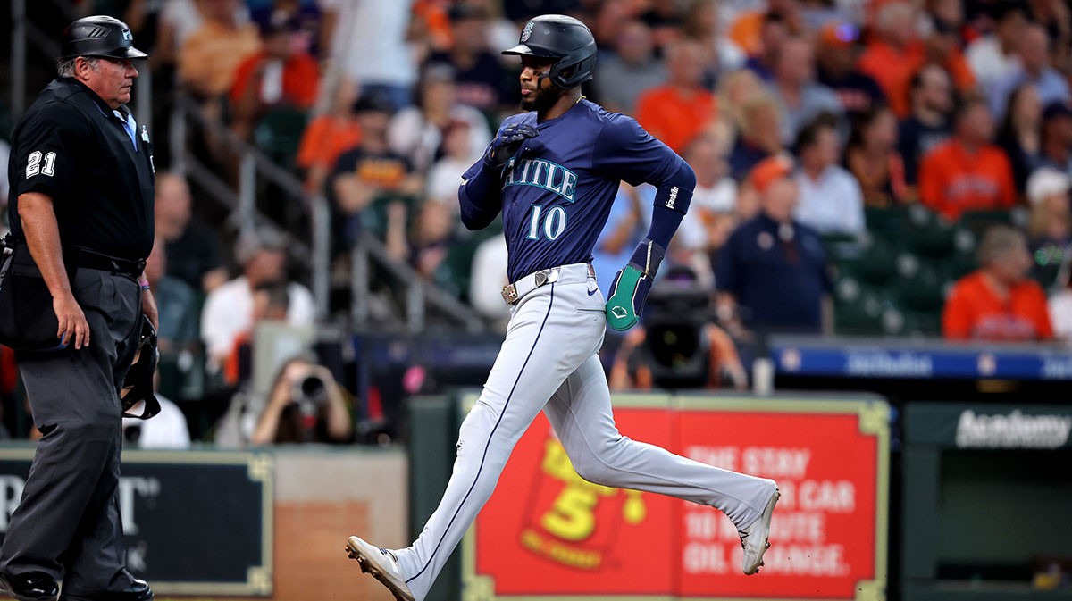 Seattle Mariners right fielder Victor Robles (10) crosses home plate to score a run against the Houston Astros during the sixth inning at Minute Maid Park.