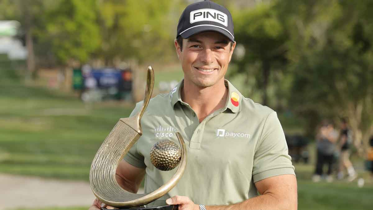 Viktor Hovland holds the champions trophy after winning the Valspar Championship golf tournament at Innisbrook Resort.