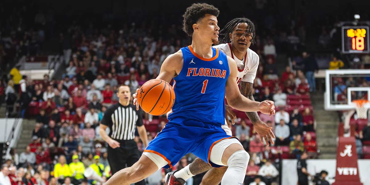 Florida Gators guard Walter Clayton Jr. (1) drives the ball against Alabama Crimson Tide guard Labaron Philon (0) during the first half at Coleman Coliseum.