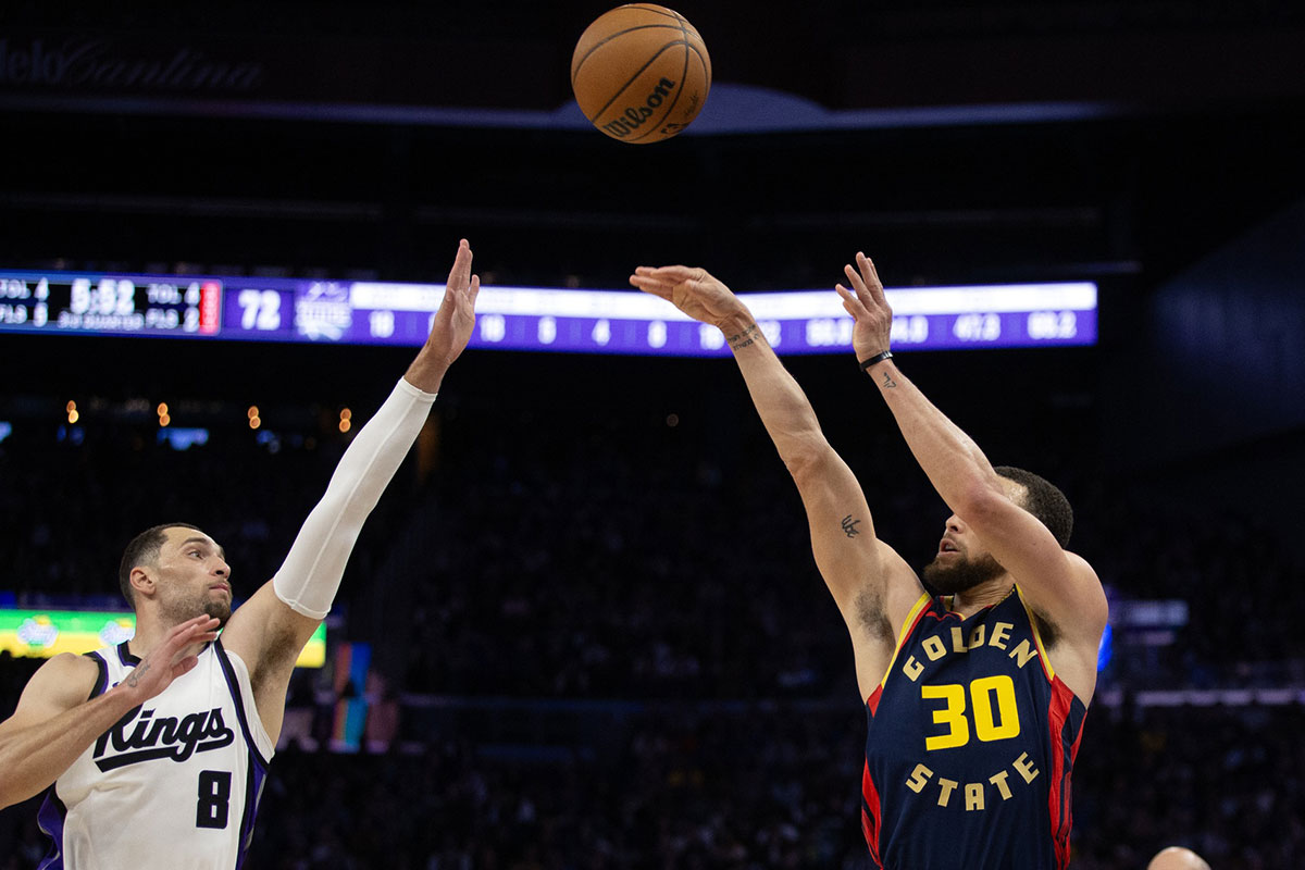 Warriors guard Stephen Curry (30) shoots over Sacramento Kings guard Zach LaVine (8) during the third quarter at Chase Center