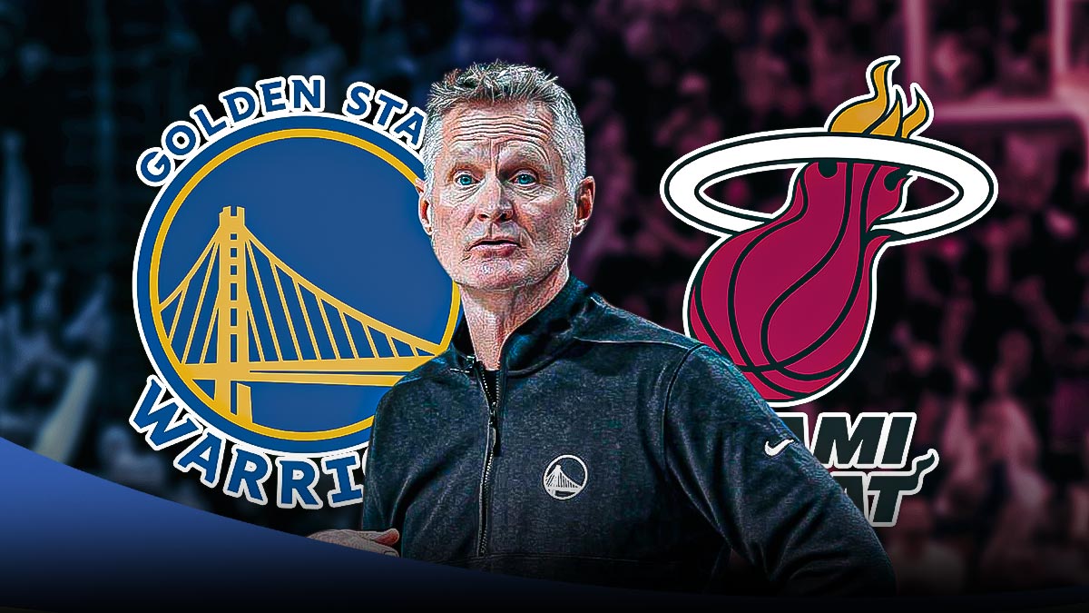 Warriors head coach Steve Kerr next to the Warriors and Heat logos excited to see Andew Wiggins