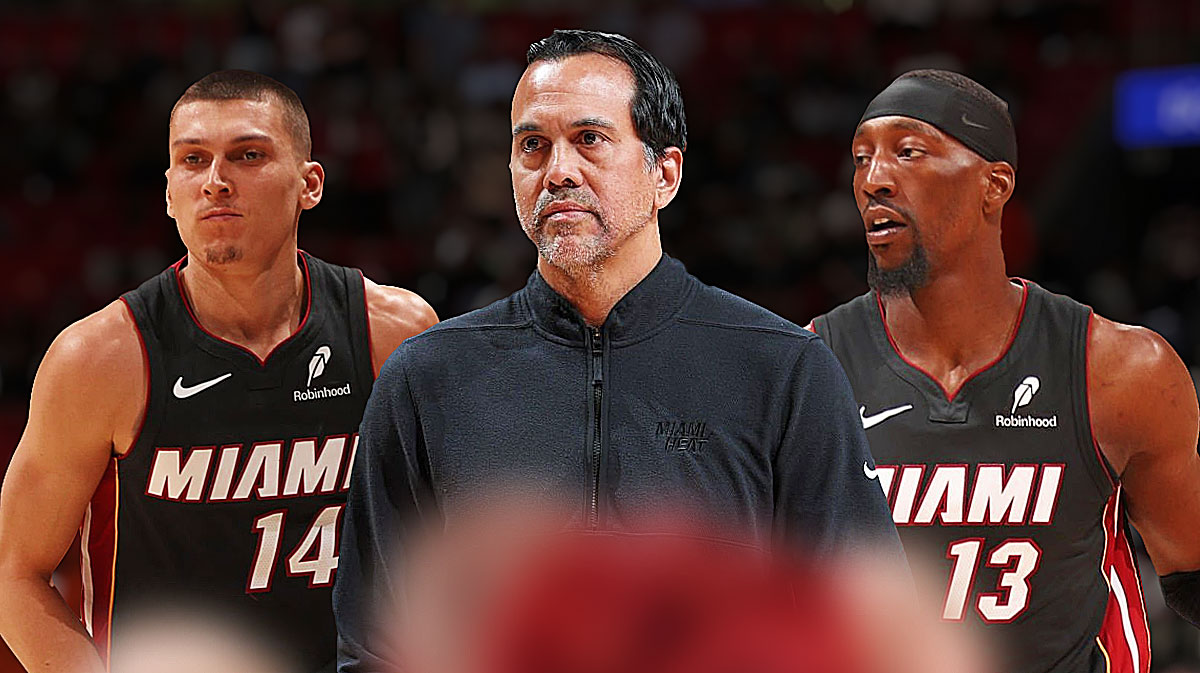 Miami Heat head coach Erik Spoelstra in the middle with Tyler Herro and Bam Adebayo on either side in front of Kaseya Center.