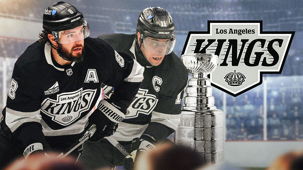 Kings stars Drew Doughty and Anze Kopitar standing next to the Stanley Cup.