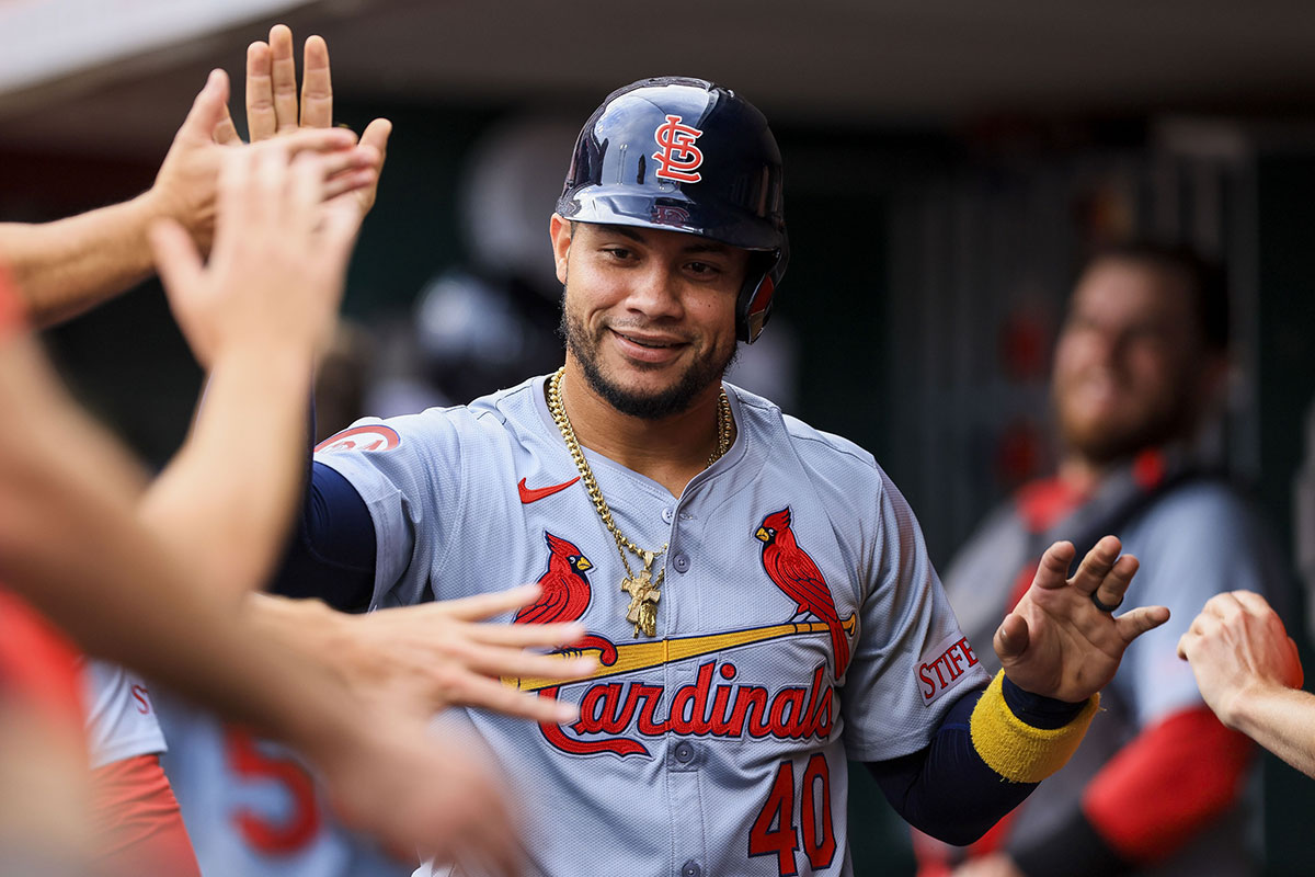 St. Louis Cardinals designated hitter Willson Contreras (40) high fives teammates after scoring on a RBI single hit by third baseman Nolan Arenado (not pictured) in the third inning at Great American Ball Park. 