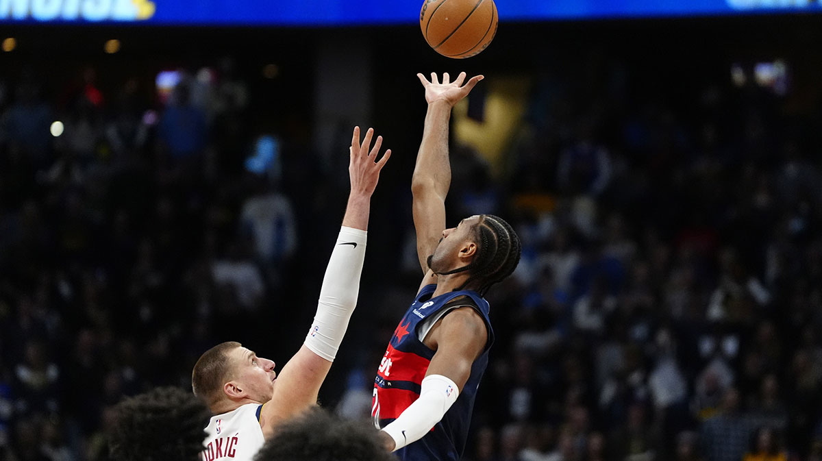 Denver Nuggets Center Nikola Jokić (15) and Washington Wizards Near Alek Sarr (20) Reach for the top in the first quarter of the Ballley Arena. 