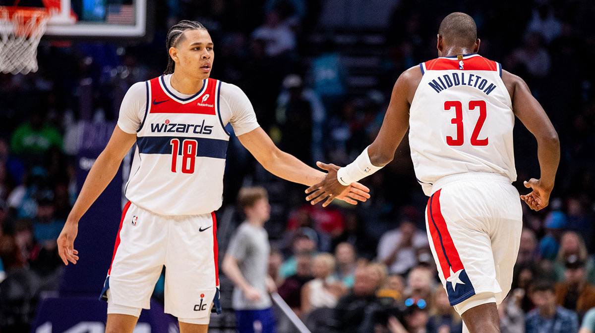 The Vizards Visards forwards KSHAVN George (18) is celebrated with advanced Khris Middleton (32) during the third quarter against Charlotte Hornet in the Spectrum Center. 