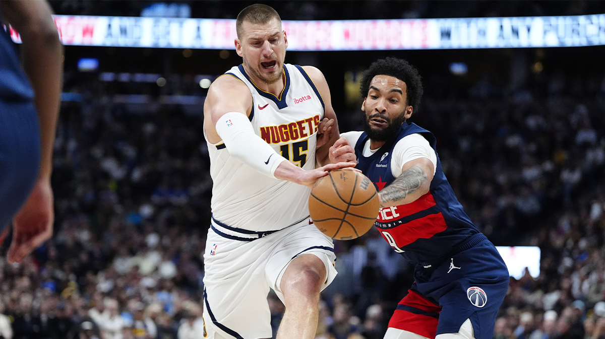 Washington Wizards forward Justin Champagnie (9) deflects a pass away from Denver Nuggets center Nikola Jokic (15) in the first quarter at Ball Arena