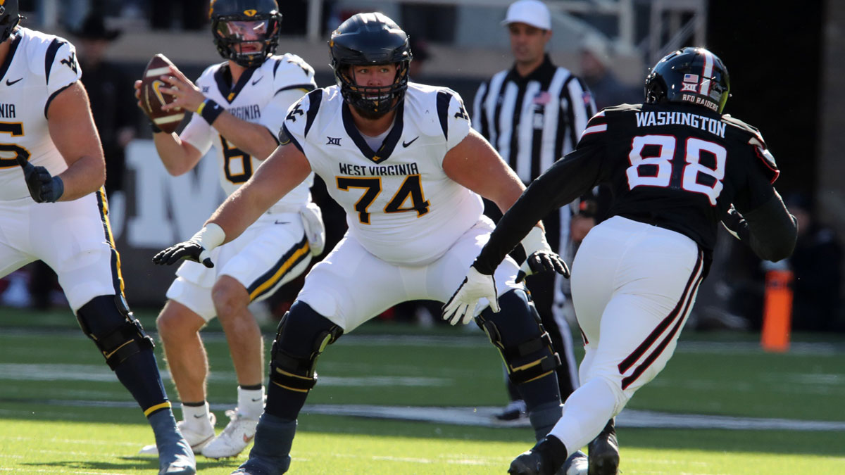 Nov 30, 2024; Lubbock, Texas, USA; West Virginia Mountaineers offensive lineman Wyatt Milum (74) prepares to block Texas Tech Red Raiders back Amier Washington (88) in the first half at Jones AT&T Stadium and Cody Campbell Field.