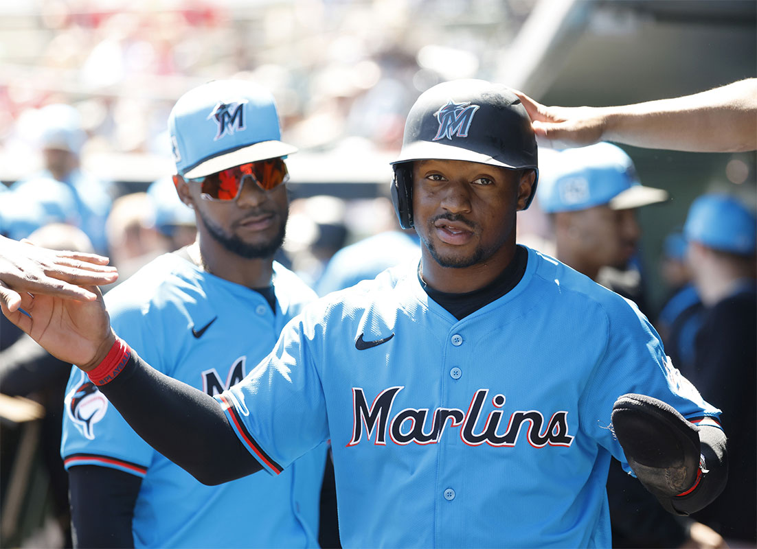 Miami Marlins shortstop Xavier Edwards (9) is congratulated in the dugout by teammates after scoring against the St. Louis Cardinals during the first inning at Roger Dean Chevrolet Stadium.