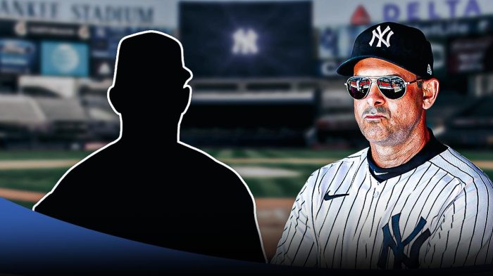 Aaron Boone next to the blacked-out silhouette of Carlos Rodon in front of the Yankees stadium.