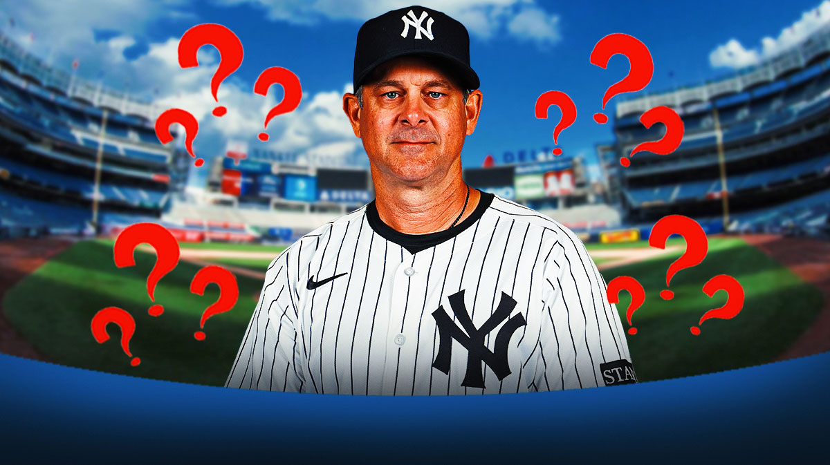 Aaron Boone, Yankee Stadium in the background. Question marks in the background.