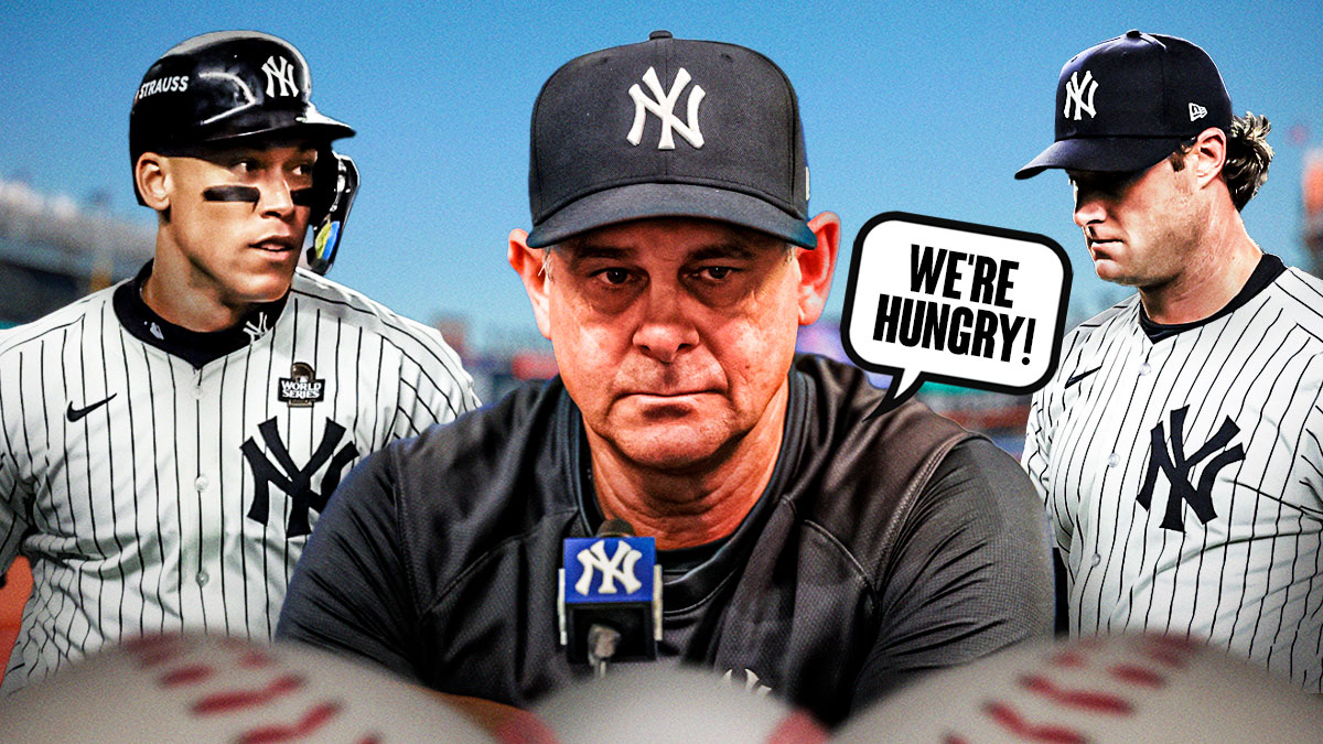 Aaron Boone looking serious and saying "We're hungry!" Aaron Judge on his left and Gerrit Cole on his right.