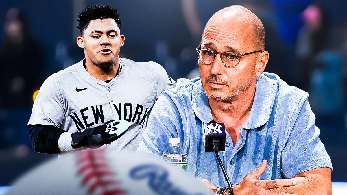 Yankees GM Brian Cashman with Jasson Dominguez in a New York Yankees uniform as Cashman hopes Dominguez can win the left field job for the yankees in spring training.