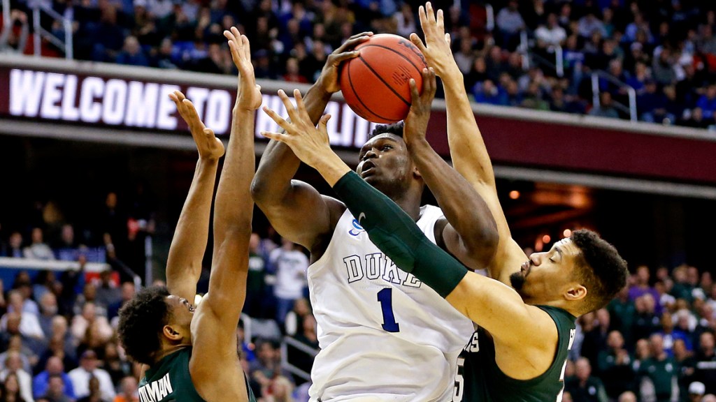 Duke Blue Devils forward Zion Williamson (1) shoots the ball against Michigan State Spartans forward Xavier Tillman (23) and Michigan State Spartans forward Kenny Goins (25) during the second half in the championship game of the east regional of the 2019 NCAA Tournament at Capital One Arena.