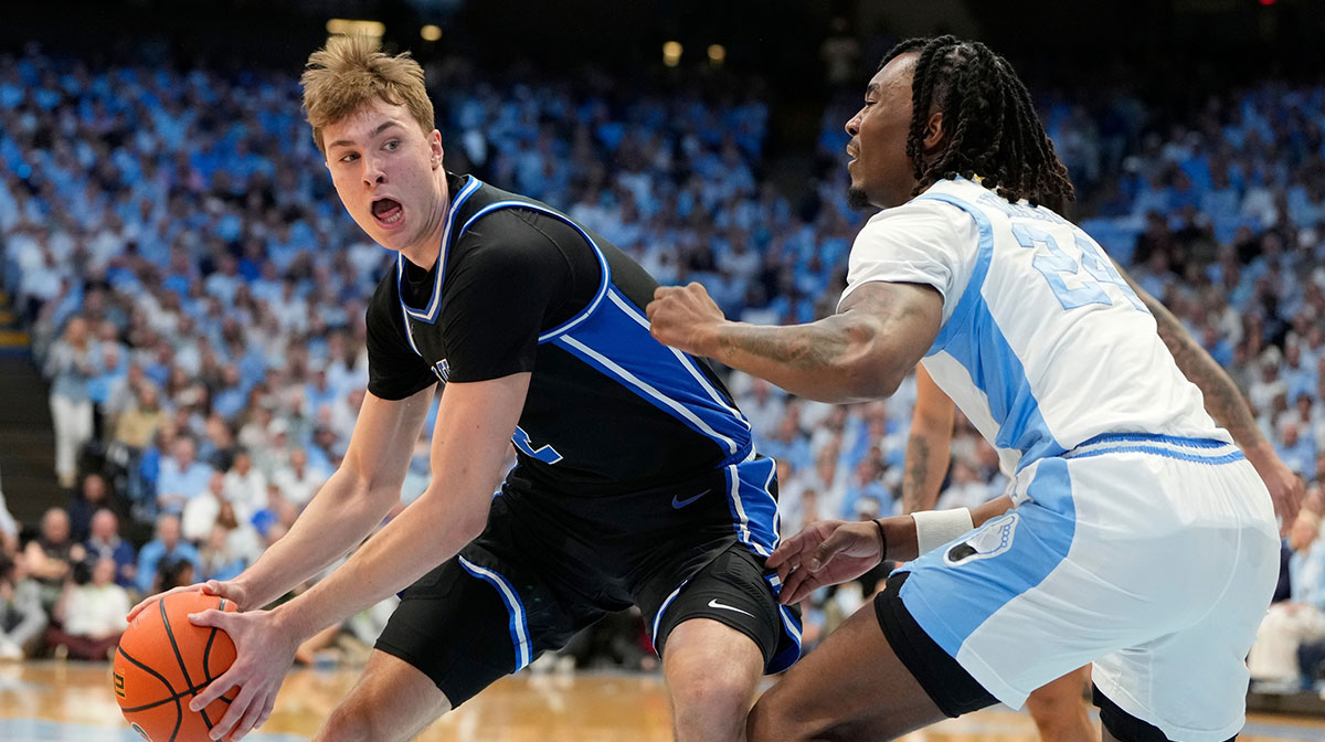 Duke Blue Devils forward Cooper Flagg (2) with the ball as North Carolina Tar Heels forward Jae'Lyn Withers (24) defend in the first half at Dean E. Smith Center.