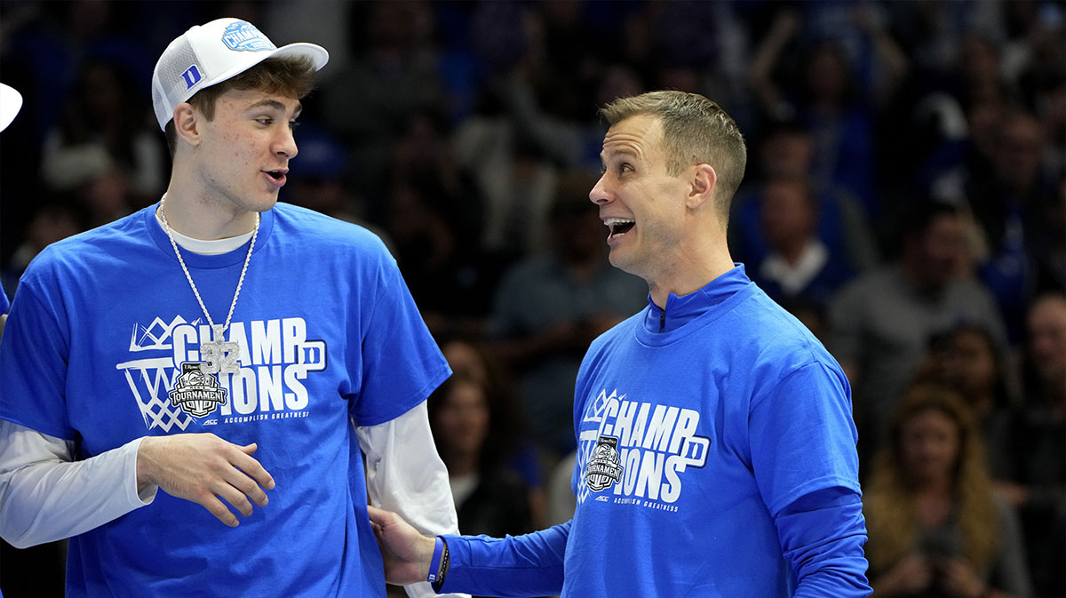 Duke Blue Devils forward Cooper Flagg (2) and head coach Jon Scheyer celebrate after winning the 2025 ACC Conference Championship game against the Louisville Cardinals at Spectrum Center.
