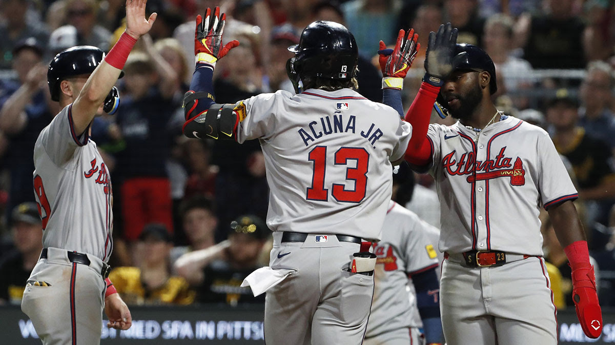 Atlanta Braves third baseman Zack Short (left) and Atlanta center fielder Michael Harris II (right) congratulate right fielder Ronald Acuna Jr. (13) crossing home plate on a three-run home run against the Pittsburgh Pirates during the eighth inning at PNC Park. 