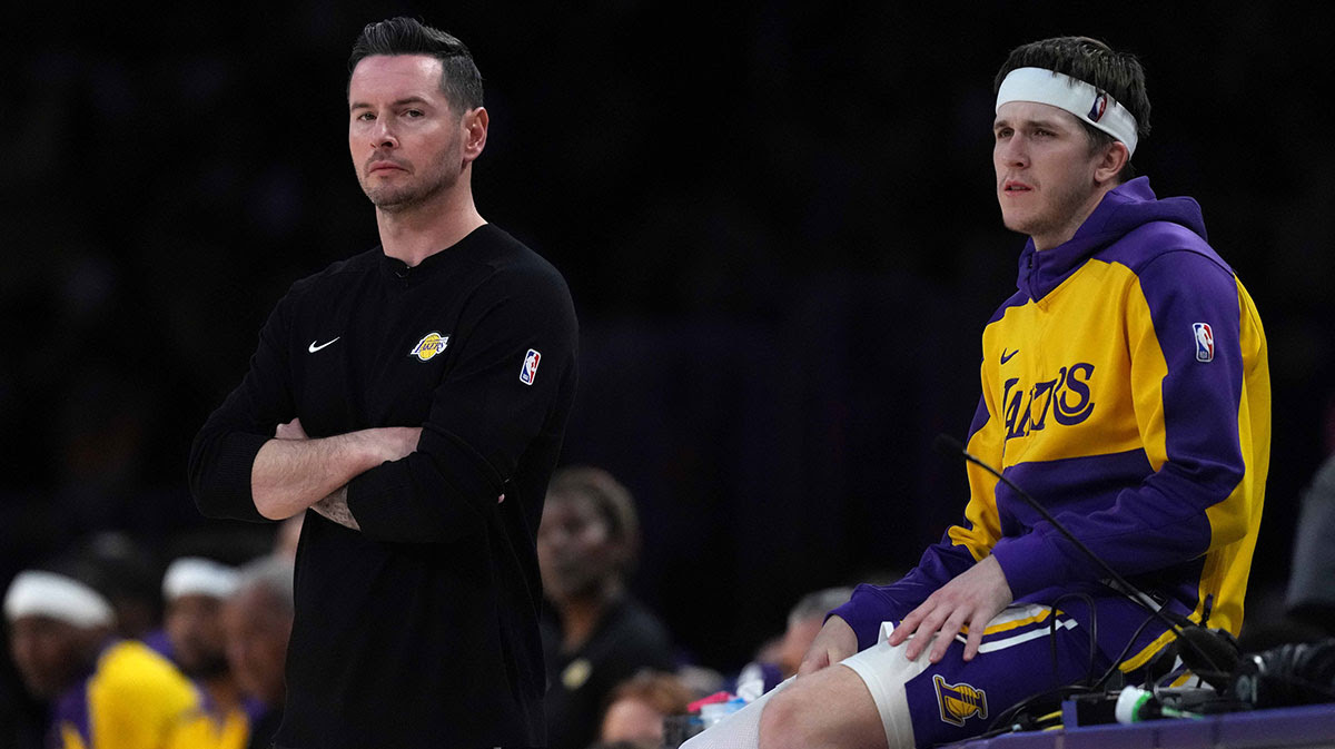 Los Angeles Lakers coach JJ Redick (left) and guard Austin Reaves (15) watch against the Phoenix Suns in the second half at Crypto.com Arena. 