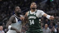 Minnesota Timberwolves forward Julius Randle (30) and Milwaukee Bucks forward Giannis Antetokounmpo (34) lock up during a free throw in the first half at Fiserv Forum.