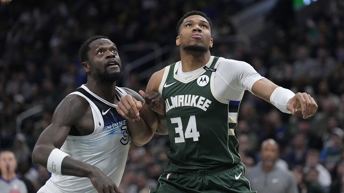 Minnesota Timberwolves forward Julius Randle (30) and Milwaukee Bucks forward Giannis Antetokounmpo (34) lock up during a free throw in the first half at Fiserv Forum.