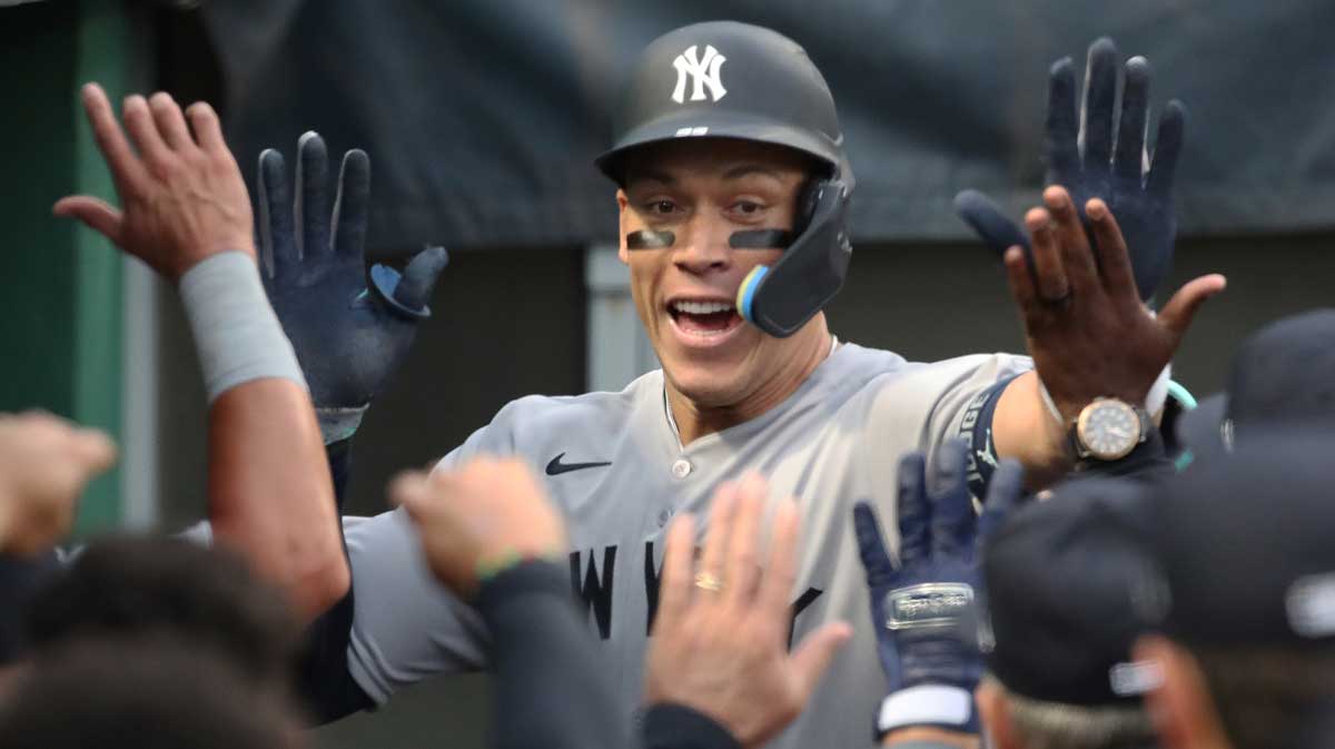New York Yankees right fielder Aaron Judge (99) high-fives in the dugout after hitting a two-run home run against the Pittsburgh Pirates during the sixth inning at PNC Park.