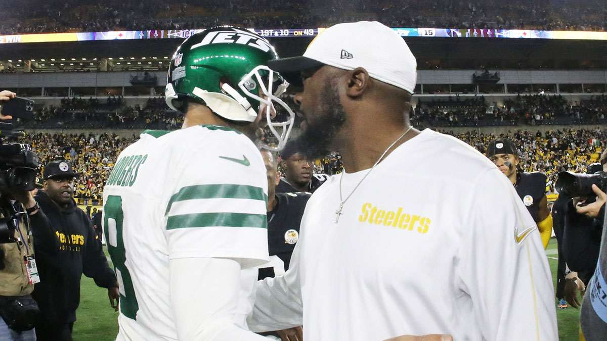 New York Jets quarterback Aaron Rodgers (8) and Pittsburgh Steelers head coach Mike Tomlin (right) greet each other after their game at Acrisure Stadium.