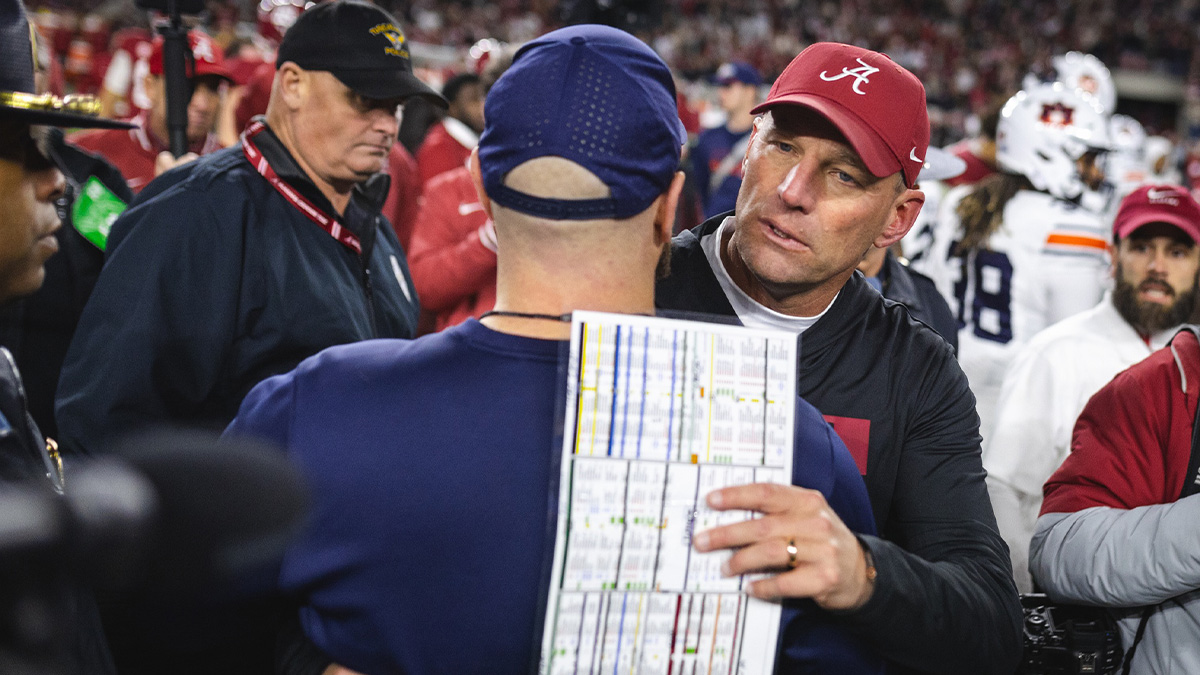 Alabama Crimson Tide head coach Kalen DeBoer hugs an Auburn Tigers official after a game at Bryant-Denny Stadium. Mandatory Credit: Will McLelland-Imagn Images
