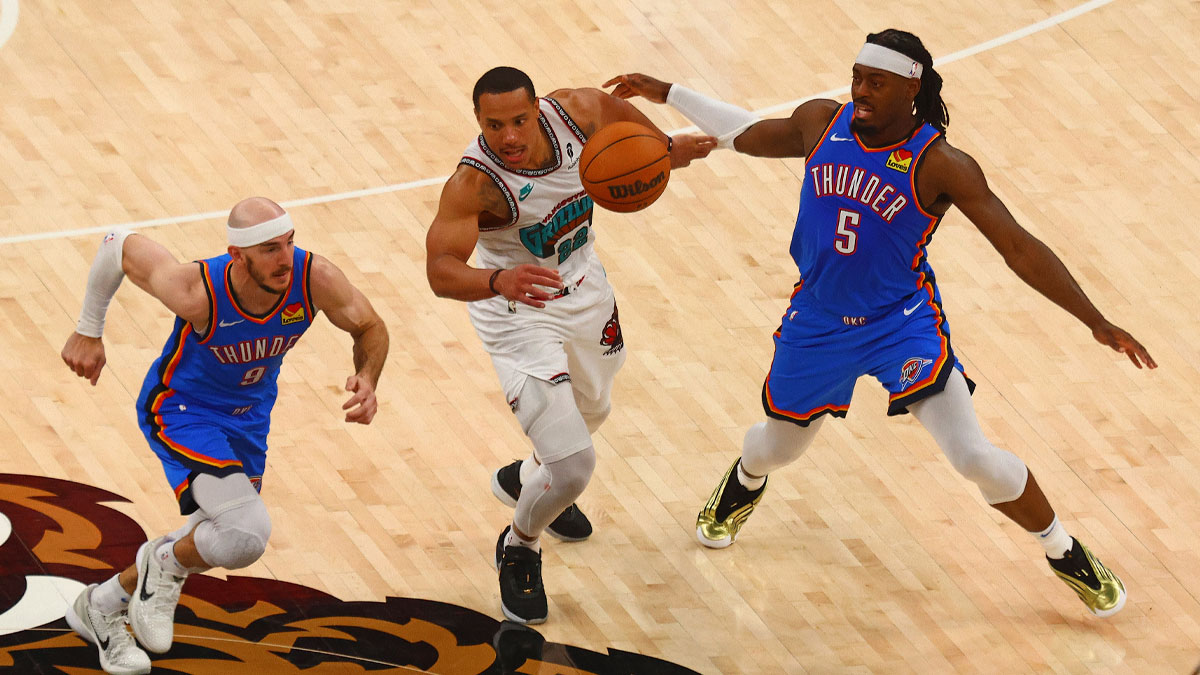 Oklahoma City Thunder guard Alex Caruso (9) and guard Luguentz Dort (5) steal the ball from Memphis Grizzlies guard Desmond Bane (22) during the fourth quarter during game three for the first round of the 2024 NBA Playoffs at FedExForum.
