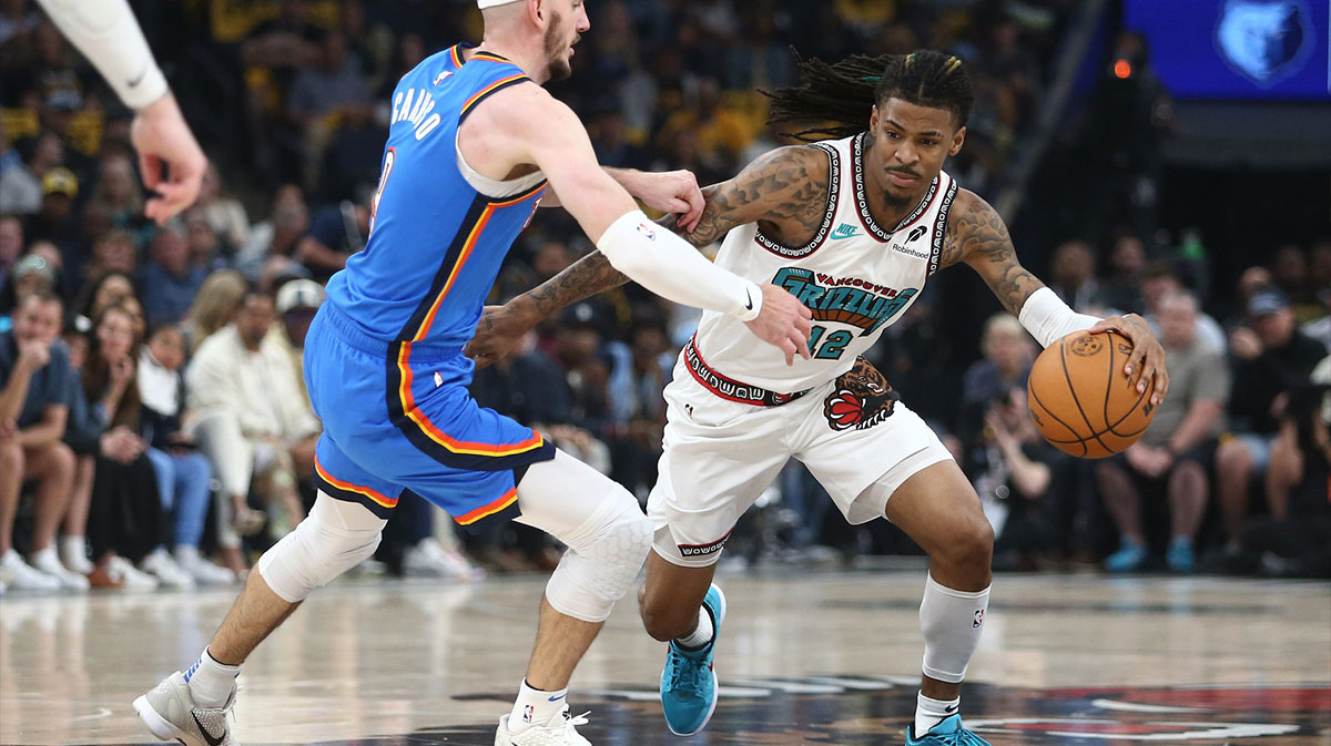 Memphis Grizzlies guard Ja Morant (12) drives to the basket as Oklahoma City Thunder guard Alex Caruso (9) defends during the second quarter during game three for the first round of the 2024 NBA Playoffs at FedExForum.